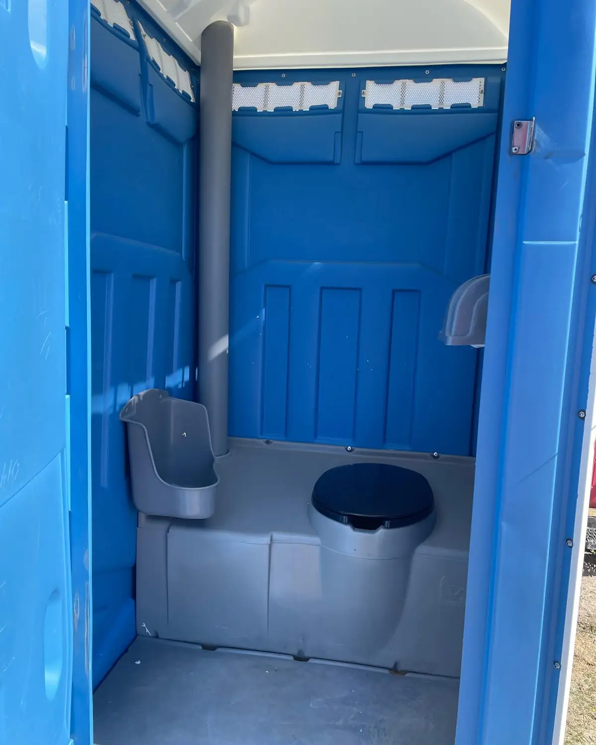 Inside a freshly serviced standard porta potty
